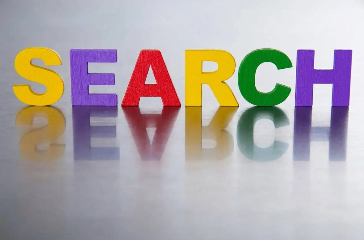 The word SEARCH in colorful felt letters on a metallic background.