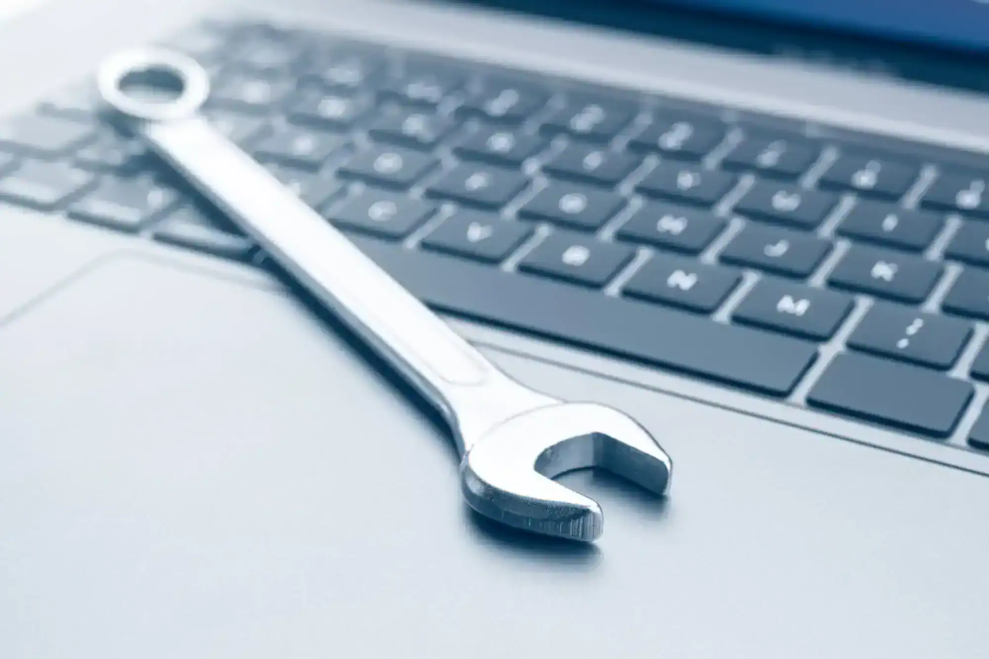 A wrench on a laptop.