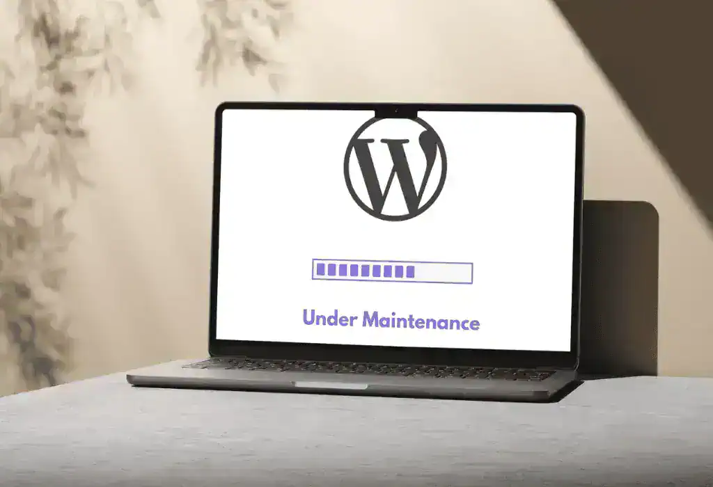 A laptop showing a WordPress logo and “Under maintenance”.