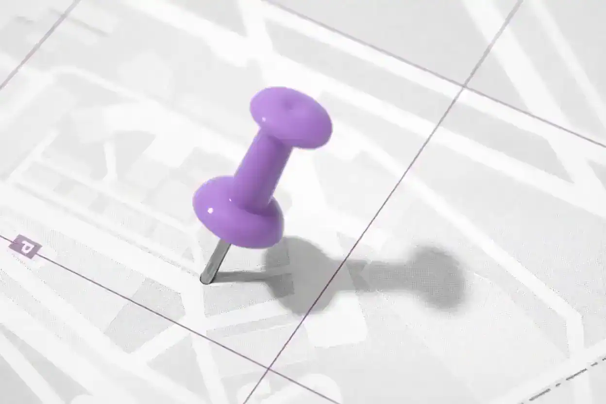 Purple pushpin marking a location on a gray street map.