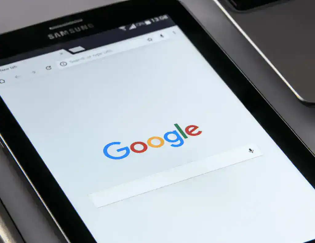 A mobile phone showing the Google search page.