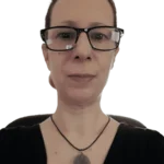 An image of Irene Koukia with glasses, at her desk.